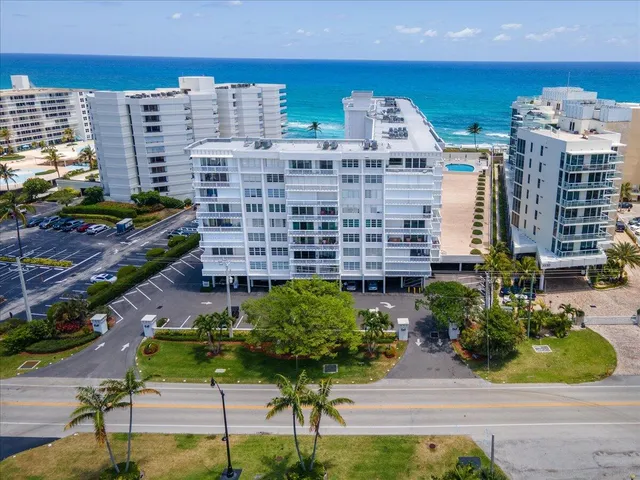 a picture of a building with a garden and plants