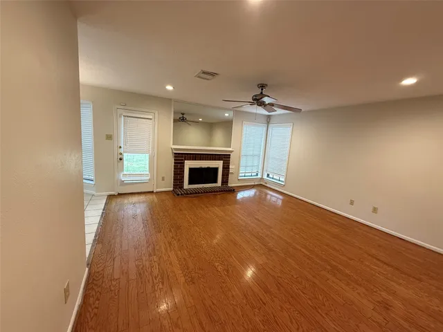 an empty room with a empty space and windows