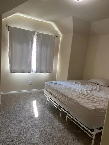 a bedroom with a bed and a mirror