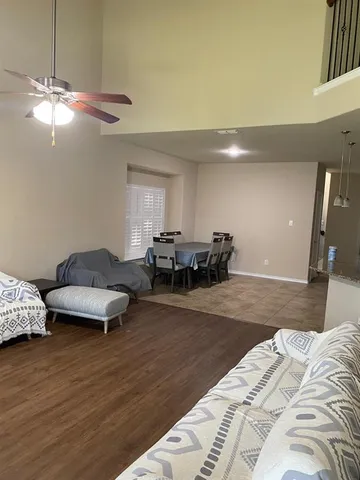 a living room with furniture and a wooden floor