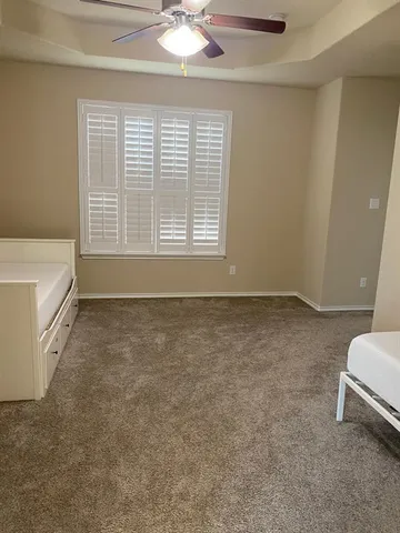 a spacious bedroom with a bed and a window