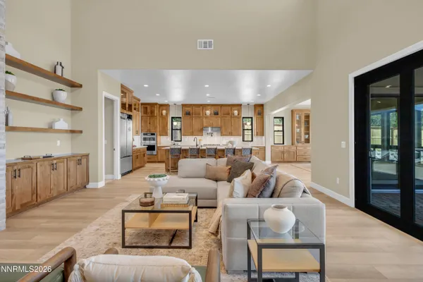 a large kitchen with lots of furniture a sink and a large window