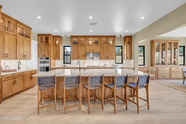 a kitchen with stainless steel appliances a sink stove and cabinets