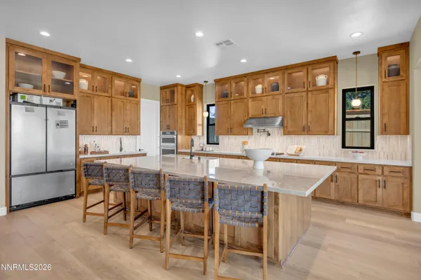 a dining room with furniture a chandelier and wooden floor
