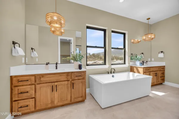 a spacious bathroom with a tub shower and a mirror