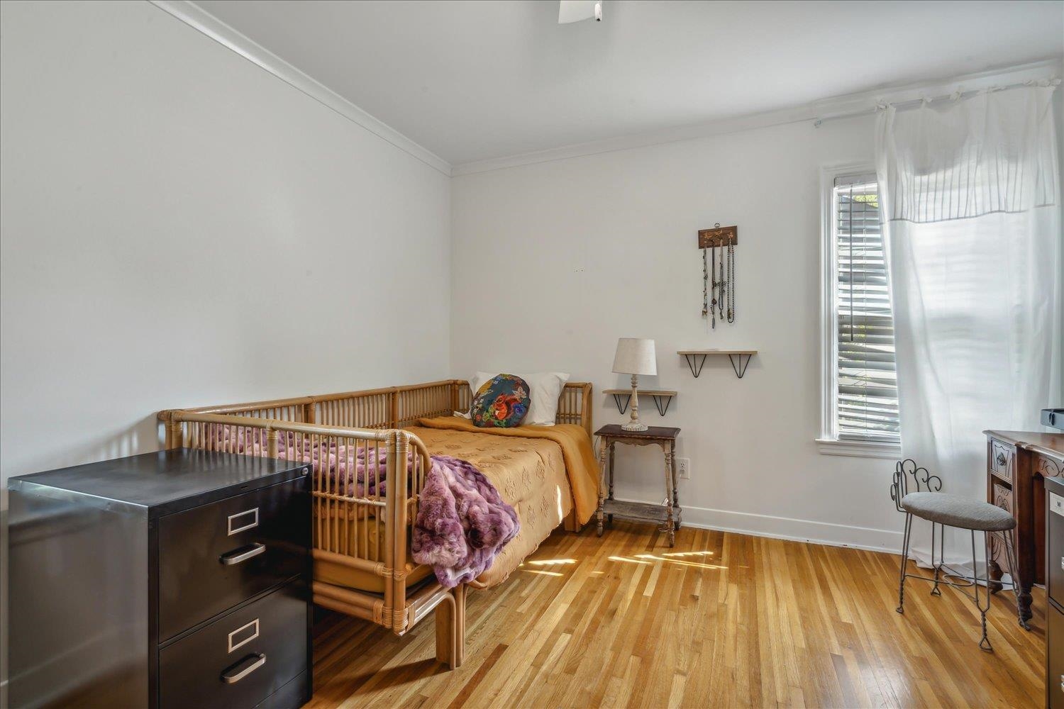1104 West Perkins Road Memphis, TN 38117 - Photo 24 of 34 a bed sitting in a bedroom next to a window