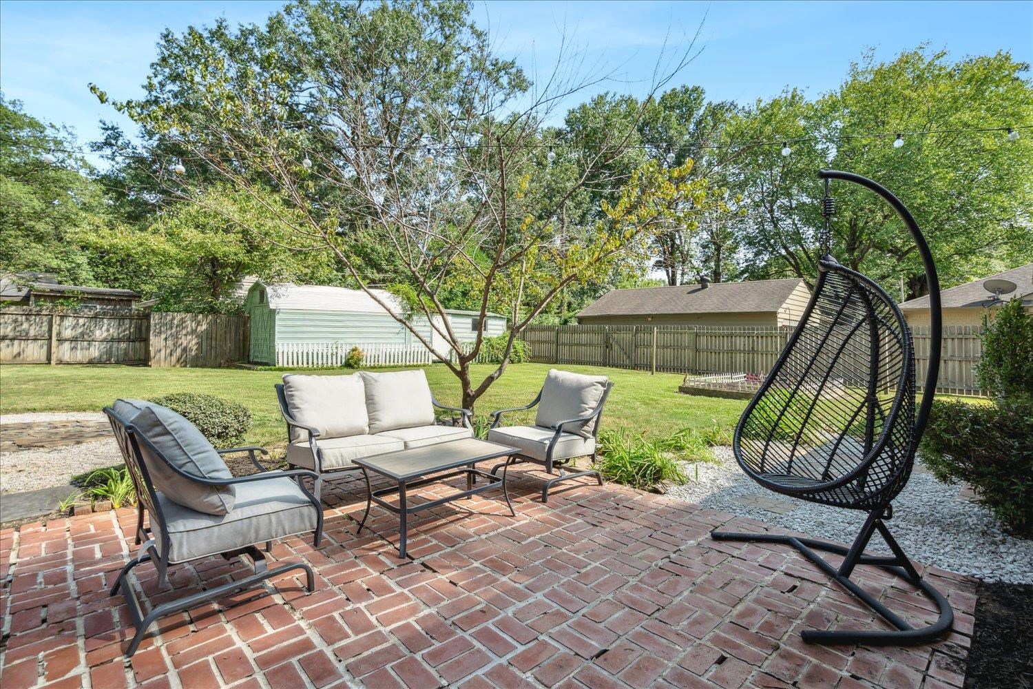 1104 West Perkins Road Memphis, TN 38117 - Photo 26 of 34 a view of a house with backyard and a sitting area