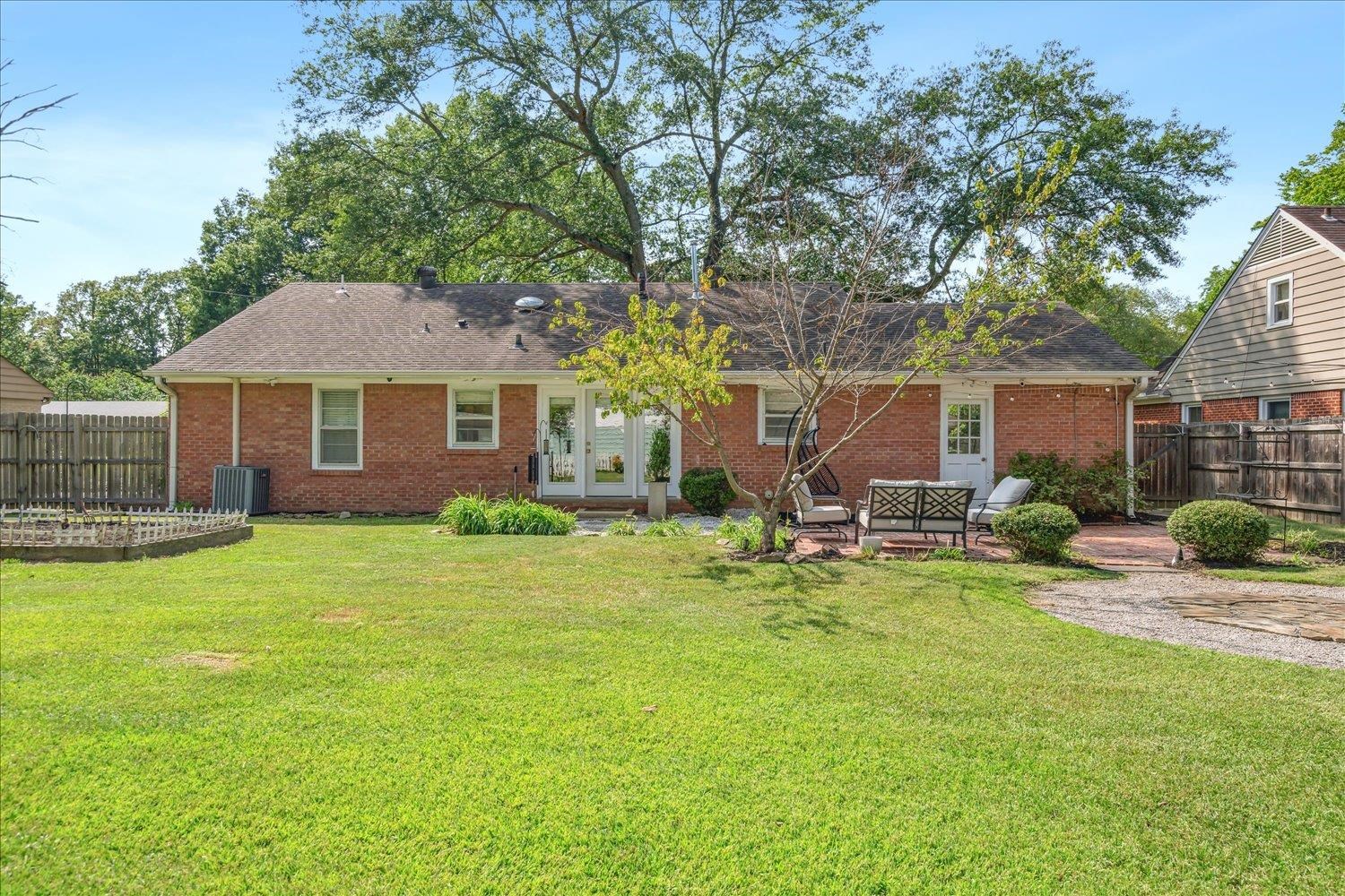 1104 West Perkins Road Memphis, TN 38117 - Photo 31 of 34 a view of backyard of house with outdoor seating and green space