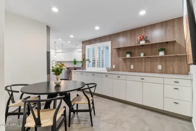 a view of kitchen with cabinets and chandelier