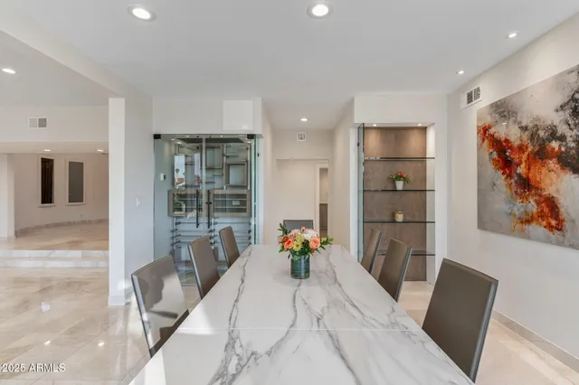 a living room with furniture ceiling fan and a floor to ceiling window