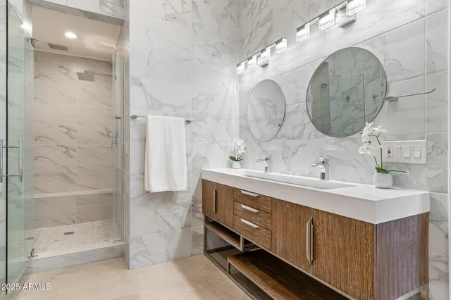 a bedroom with a large bed and a potted plant