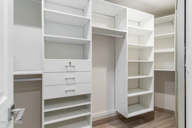 a view of room with window and wooden floor