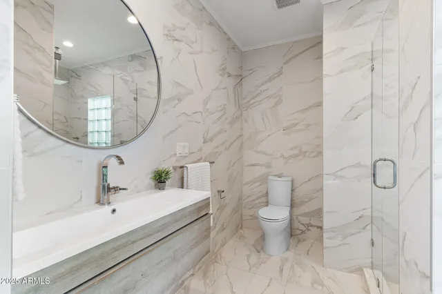 a bathroom with a sink toilet and shower
