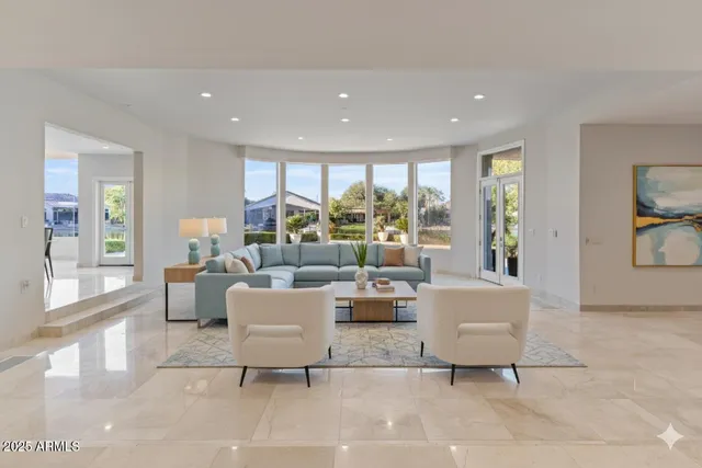 a kitchen with kitchen island granite countertop a sink a counter space appliances and a center island