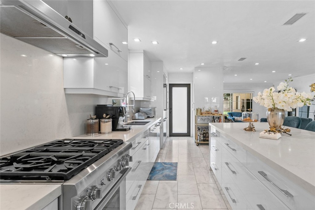 2640 North Keystone Street Burbank, CA 91504 - Photo 11 of 48 a kitchen with stainless steel appliances kitchen island granite countertop a lot of counter space and a sink