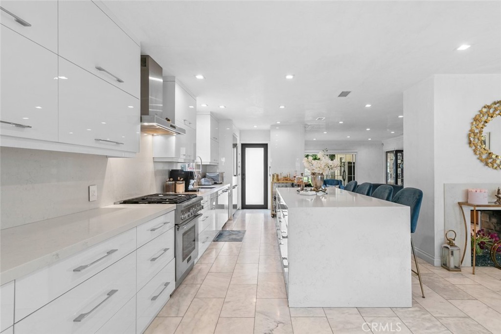 2640 North Keystone Street Burbank, CA 91504 - Photo 12 of 48 a large kitchen with stainless steel appliances kitchen island a stove a sink a refrigerator and a cabinets
