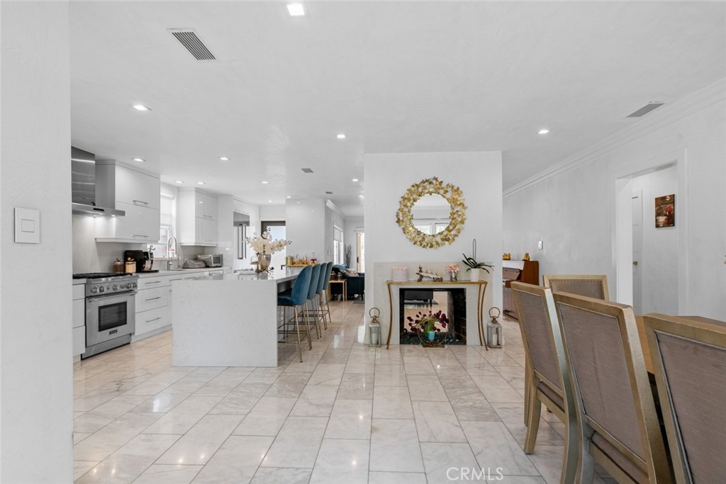 2640 North Keystone Street Burbank, CA 91504 - Photo 13 of 48 a living room with furniture a clock and a view of kitchen
