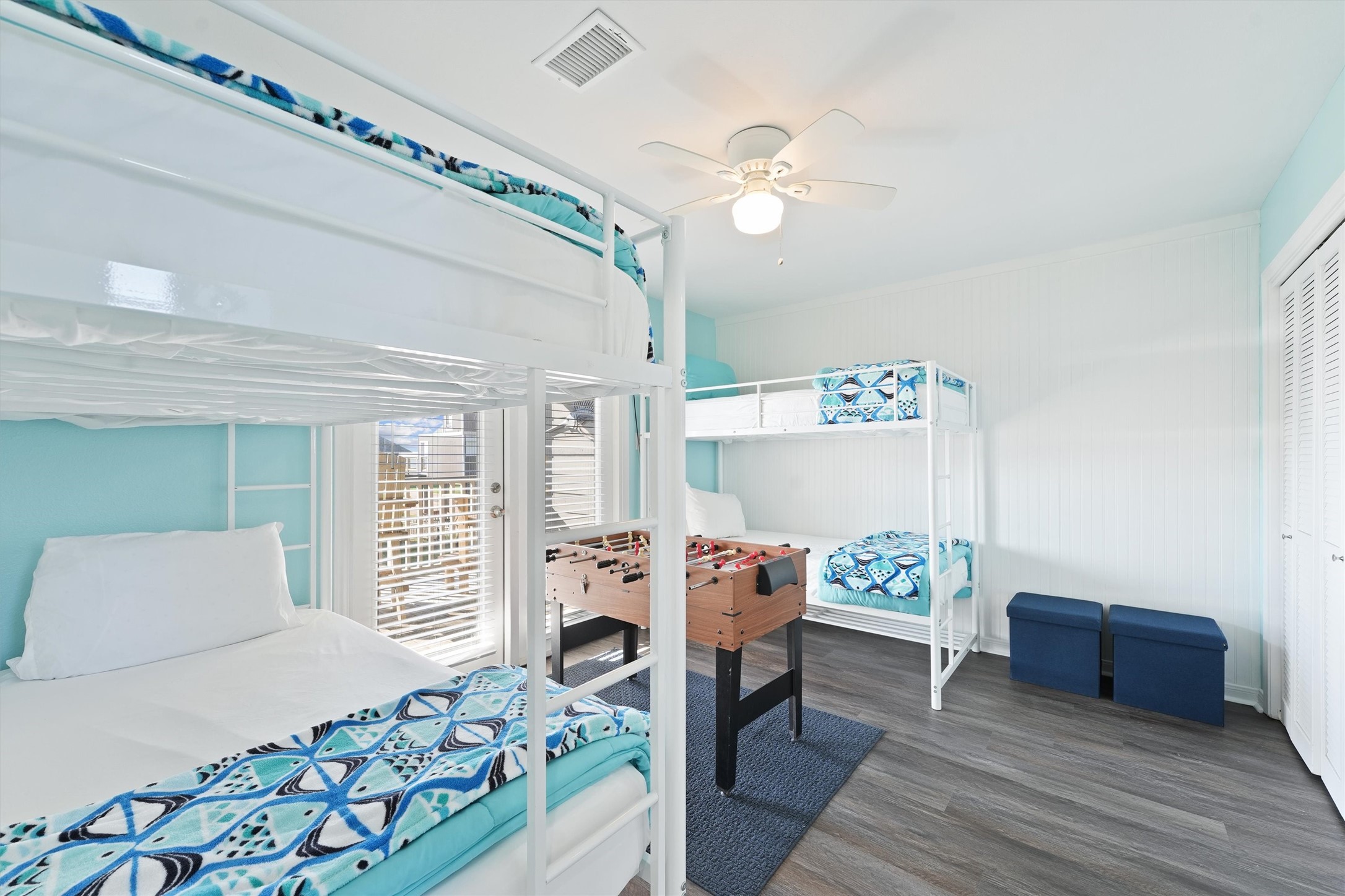 17607 Termini-San Luis Pass Road Galveston, TX 77554 - Photo 27 of 42 The second bedroom features four cozy bunk beds, perfect for accommodating family and friends. A foosball table in the center adds a touch of fun to this comfortable space.