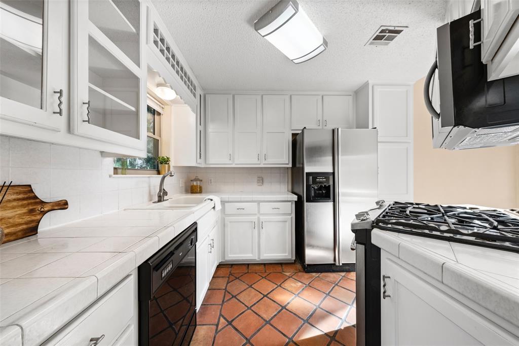 3825 North 30th Street Waco, TX 76708 - Photo 15 of 38 a kitchen with stainless steel appliances granite countertop a refrigerator sink and stove