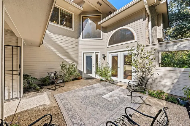 a view of an house with backyard and sitting area