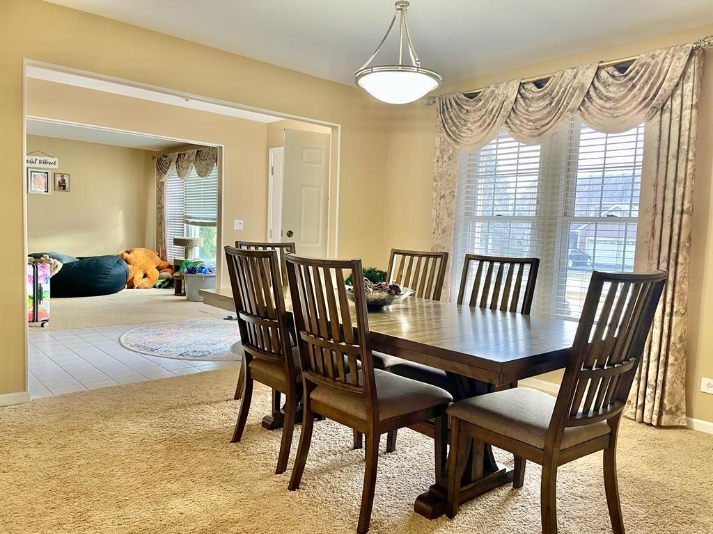 1236 Sagebrush Trail Cary, IL 60013 - Photo 5 of 17 a view of a dining room with furniture and a chandelier