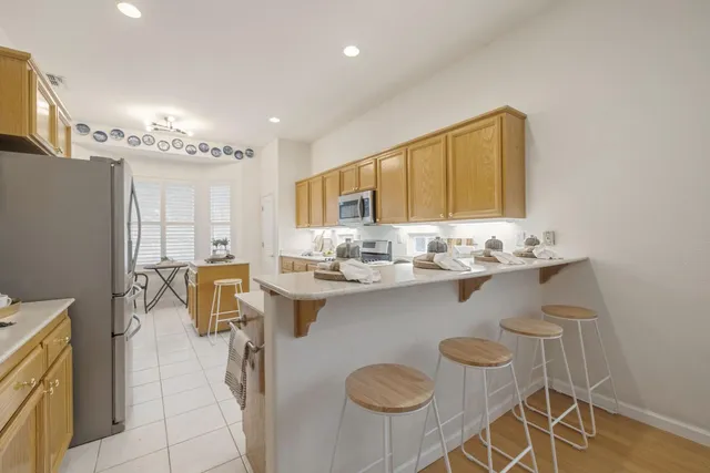 a kitchen with a sink cabinets and dining table