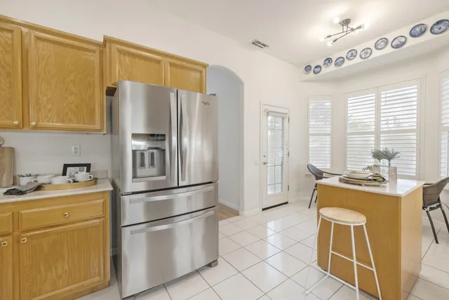a kitchen with stainless steel appliances a stove a refrigerator and cabinets