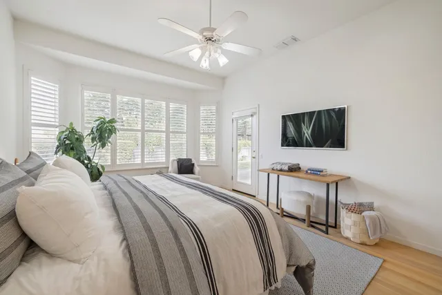 a bedroom with a bed and a flat screen tv