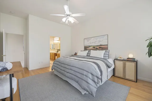 a bedroom with a bed and wooden floor