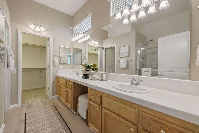 a spacious bathroom with a double vanity sink mirror and double