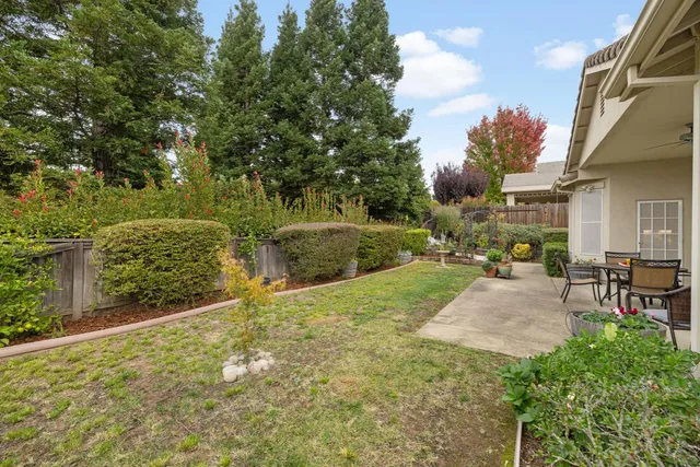 a view of backyard with seating area and green space