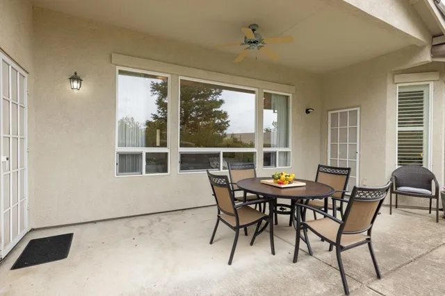 a view of a dining room with furniture and a window