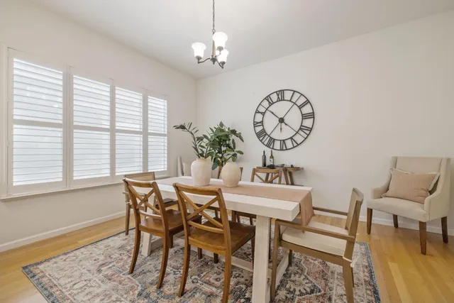 a view of a dining room with furniture and chandelier