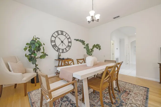 a view of a dining room with furniture and chandelier