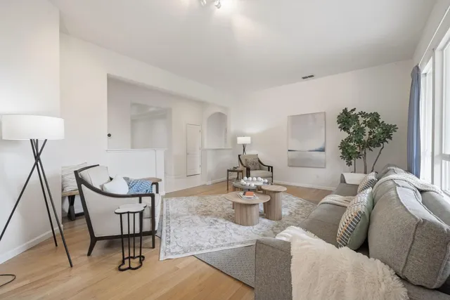 a living room with furniture a table and chair