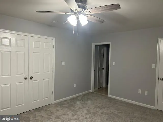 a view of empty room with ceiling fan