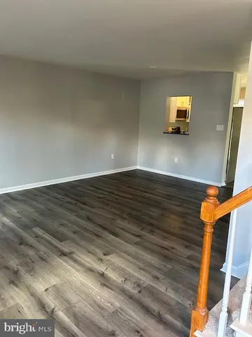 a view of an empty room and wooden floor