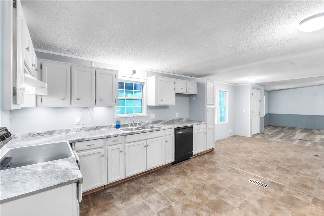 178 Childress Road Pickens, SC 29671 - Photo 5 of 32 A well-appointed kitchen features ample white cabinetry, sleek countertops, and modern appliances.