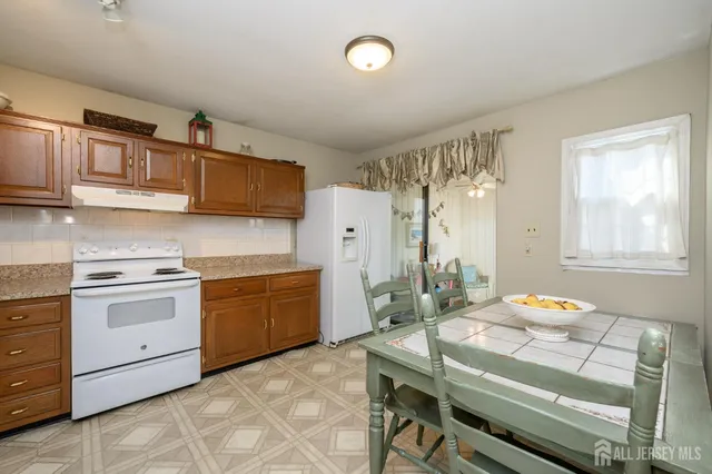a kitchen with a stove a sink and a refrigerator