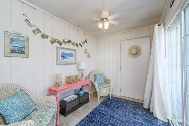 a bedroom with a bed and a chandelier fan