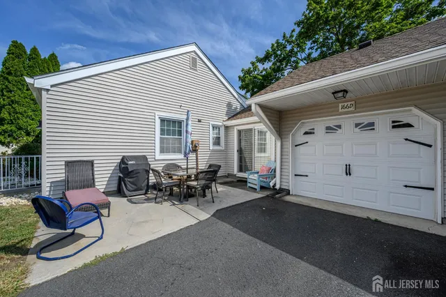 a view of a patio with table and chairs with wooden floor and fence