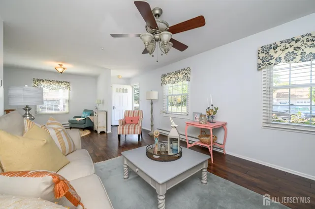 a living room with furniture a window and a table