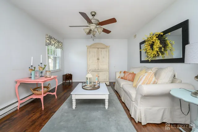 a living room with furniture and a ceiling fan