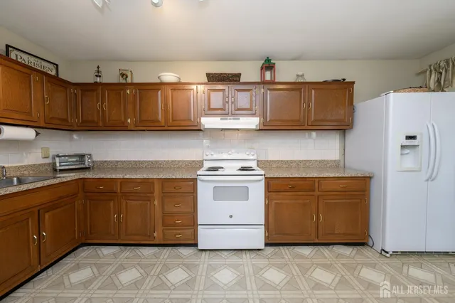 a kitchen with stainless steel appliances granite countertop a stove and a refrigerator