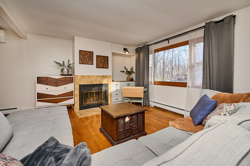 15 Gulf Road Pelham, MA 01002 - Photo 12 of 42 a living room with furniture a window and a fireplace