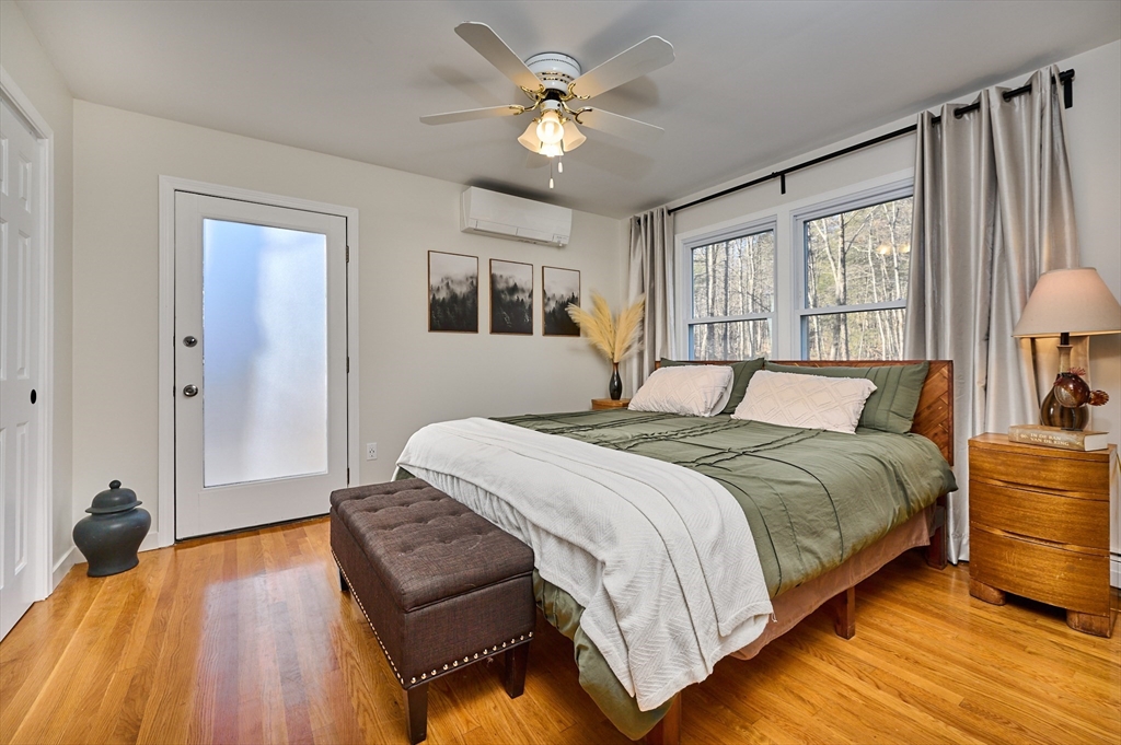 15 Gulf Road Pelham, MA 01002 - Photo 13 of 42 a bedroom with a bed and wooden floor