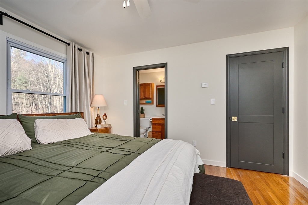 15 Gulf Road Pelham, MA 01002 - Photo 14 of 42 a bedroom with a bed and a large window