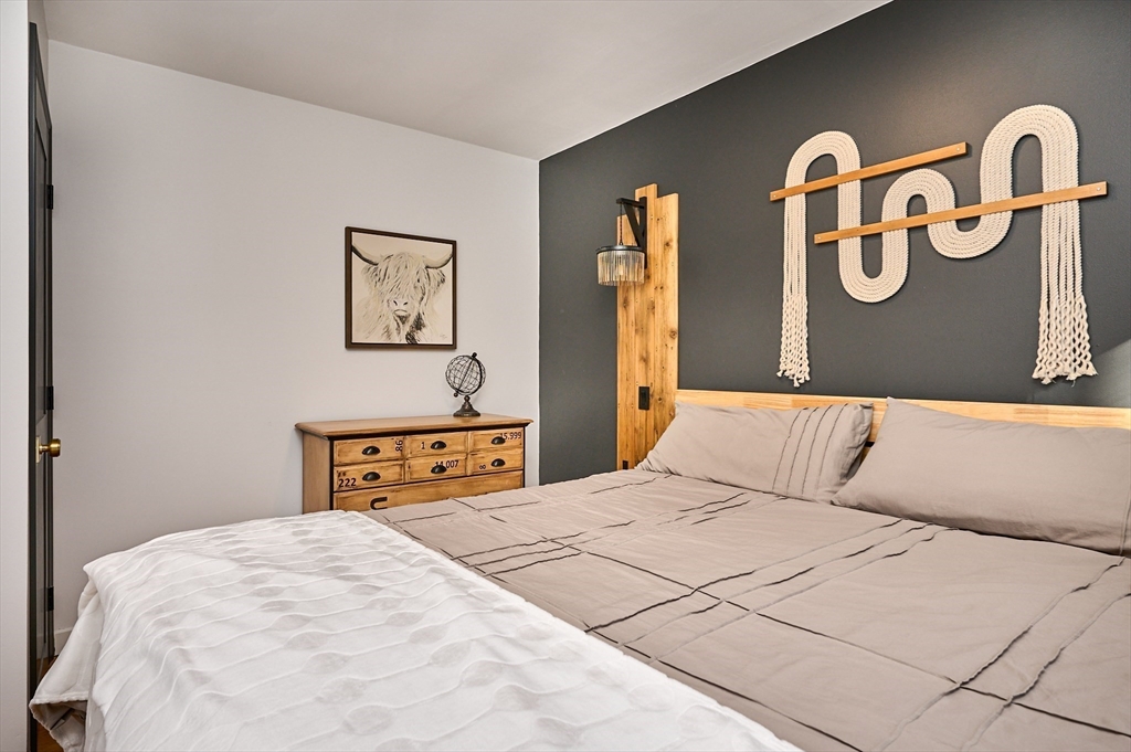 15 Gulf Road Pelham, MA 01002 - Photo 18 of 42 a bedroom with a bed and a table