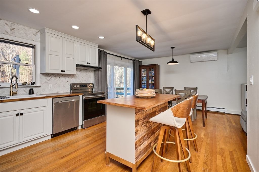 15 Gulf Road Pelham, MA 01002 - Photo 9 of 42 a kitchen with stainless steel appliances kitchen island granite countertop a stove a sink and a refrigerator