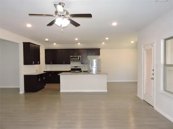 a kitchen with a sink and a stove top oven